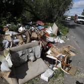 Fly-tipped rubbish and waste is seen beside a road in Colnbrook, near Heathrow (image: AFP via Getty Images)