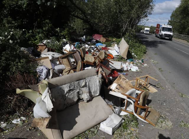 Fly-tipped rubbish and waste is seen beside a road in Colnbrook, near Heathrow (image: AFP via Getty Images)