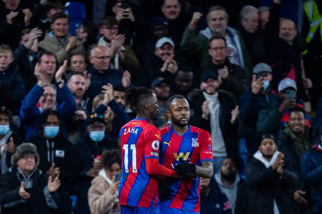Jordan Ayew celebrates with Wilfried Zaha of Crystal Palace after scoring (Photo by Sebastian Frej/MB Media/Getty Images)