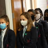 Face covering recommendations are being reintroduced for students returning to schools in England (Photo: OLI SCARFF/AFP via Getty Images)