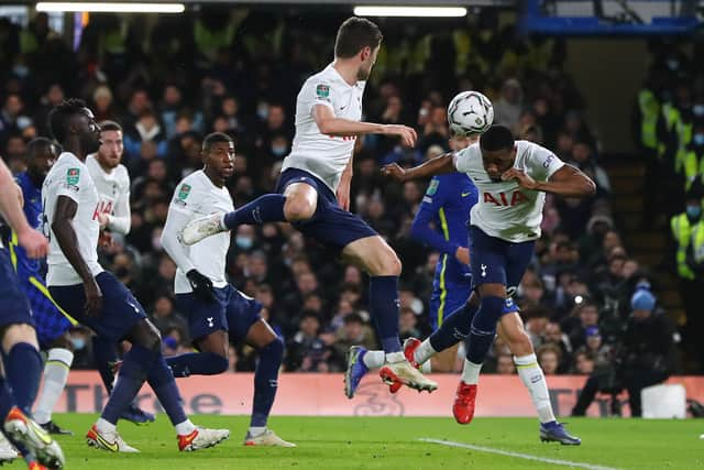 Japhet Tanganga of Tottenham Hotspur heads the ball on to Ben Davies of Tottenham Hotspur (Photo by Chloe Knott - Danehouse/Getty Images)