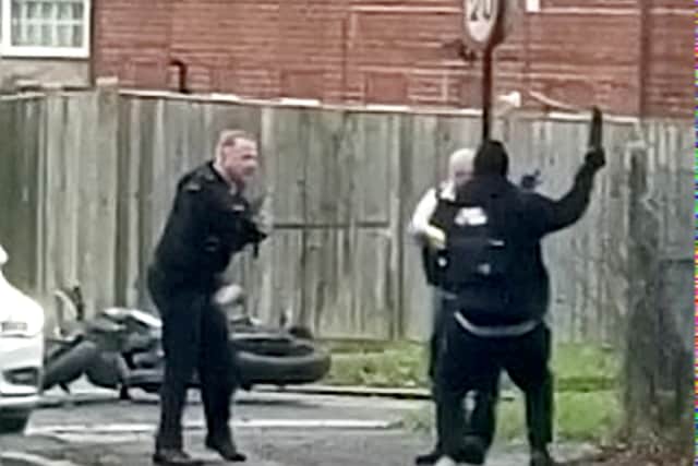 A man can be seen in a tussle with the officer at a t-junction in South Croydon, London. Credit: Robert Ball / SWNS