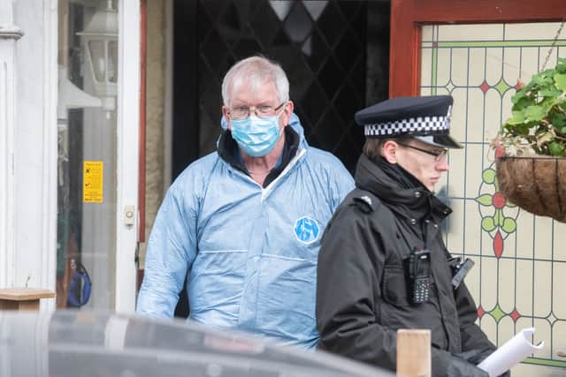 Scene of crime investigator at the home where  a man and woman have been found dead after a fire tore through a house in Croydon on Wednesday night. Credit: Tony Kershaw / SWNS