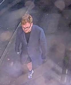 The first witness is white, with ginger hair and black glasses, and was wearing a long grey coat, shorts and trainers. Photo: Met Police