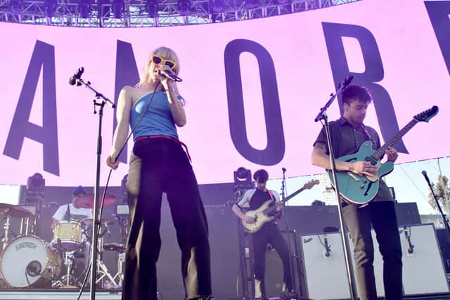 Zac Farro, Hayley Williams, and Josh Farro of Paramore perform onstage in California (Photo: Alberto E. Rodriguez/Getty Images for CBS Radio Inc.)