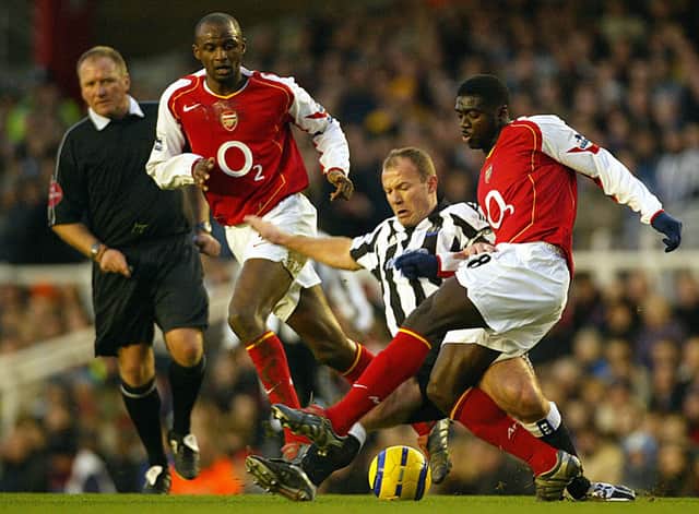 Alan Shearer battles with Kolo Toure and Patrick Vieira at Highbury in 2005. Credit: JIM WATSON/AFP via Getty Images