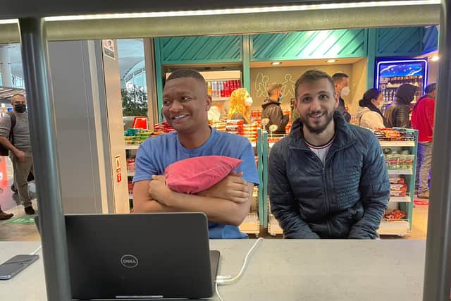 Football reporter Rahman Osman, left, writing his piece stranded at Istanbul Airport. Credit: Rahman Osman
