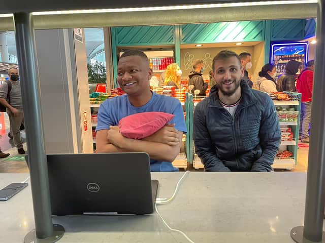 Football reporter Rahman Osman, left, writing his piece stranded at Istanbul Airport. Credit: Rahman Osman