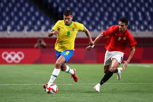  Bruno Guimaraes #8 of Team Brazil runs with the ball whilst under pressure from Taher Mohamed #9 of Team Egypt during the Men's Quarter Final between Brazil and Egypt on day eight of the Tokyo Olympic Games at Saitama Stadium on July 31, 2021 in Saitama, Japan