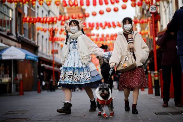 Two women celebrating Chinese New Year in Chinatown last year. Credit: TOLGA AKMEN/AFP via Getty Images