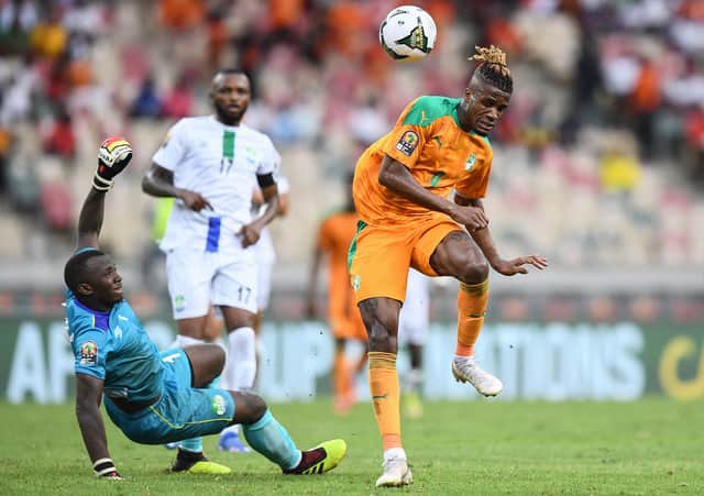 Wilfred Zaha (R) makes an unsuccessful attempt at goal as Sierra Leone's goalkeeper  (Photo by CHARLY TRIBALLEAU / AFP) (Photo by CHARLY TRIBALLEAU/AFP via Getty Images)