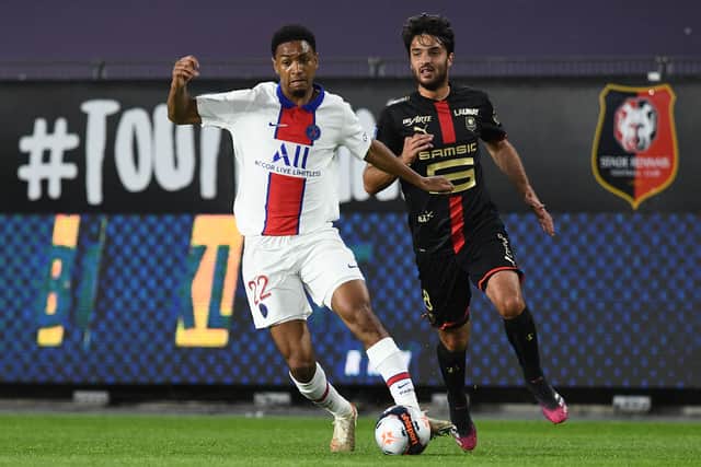 Paris Saint-Germain's French defender Abdou Diallo (L) is challenged by Rennes' French midfielder Clement Grenier (Photo by FRED TANNEAU/AFP via Getty Images)