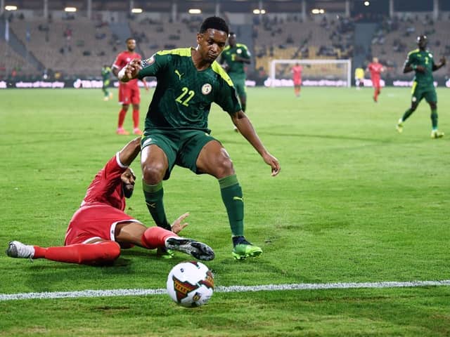 Equatorial Guinea’s forward Emilio Nsue (L) tackles Senegal’s defender Abdou Diallo  during the Africa Cup of Nations. Credit:  CHARLY TRIBALLEAU/AFP via Getty Images