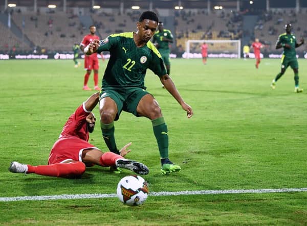 Equatorial Guinea’s forward Emilio Nsue (L) tackles Senegal’s defender Abdou Diallo  during the Africa Cup of Nations. Credit:  CHARLY TRIBALLEAU/AFP via Getty Images