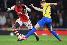 Nicolas Pepe of Arsenal takes on Tom Flanagan of Sunderland during the Carabao Cup Quarter Final match between Arsenal and Sunderland at Emirates Stadium on December 21, 2021 in London, England