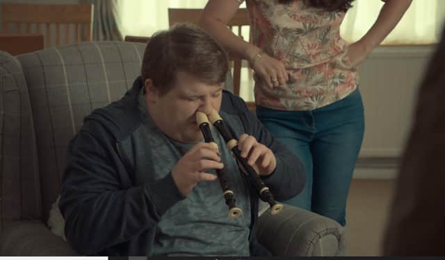 Ethan attempts playing two recorders with his nose in After Life (Photo: Netflix)