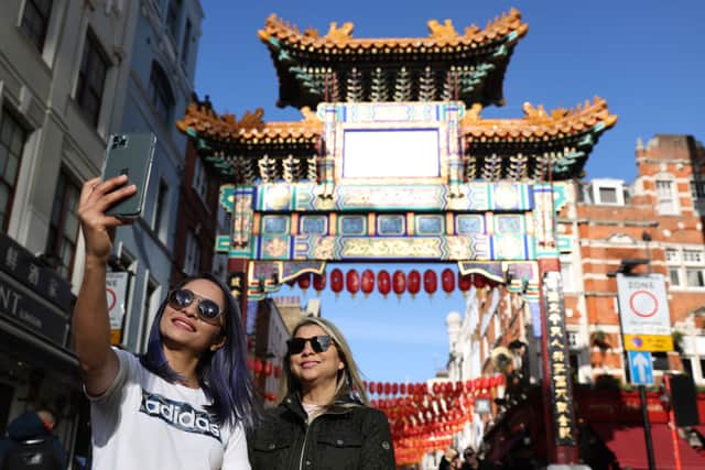 People take selfies in Chinatown ahead of Chinese New Year. Credit: Hollie Adams/Getty Images