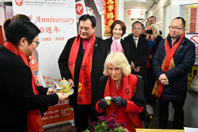Camilla, Duchess of Cornwall (R) receives a cup of tea during a visit of the Chinese Information And Advice Centre while taking part in the celebrations on the occasion of the Lunar New Year . Credit: Justin Tallis - WPA Pool /Getty Images
