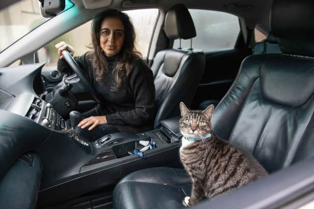 Tahira Sarwar, 47, says her moggy Mika has developed an unusual love for spending time on the road - and won’t let her go out without him. Credit: Tony Kershaw / SWNS