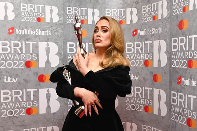  Adele poses with her award in the media room during The BRIT Awards 