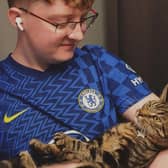 Kurt Zouma super fan Ollie Hall with Burt, formerly Kurt, the cat. Credit: Ollie Hall / SWNS
