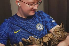 Kurt Zouma super fan Ollie Hall with Burt, formerly Kurt, the cat. Credit: Ollie Hall / SWNS