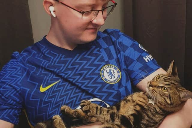 Kurt Zouma super fan Ollie Hall with Burt, formerly Kurt, the cat. Credit: Ollie Hall / SWNS