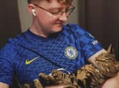 Kurt Zouma super fan Ollie Hall with Burt, formerly Kurt, the cat. Credit: Ollie Hall / SWNS