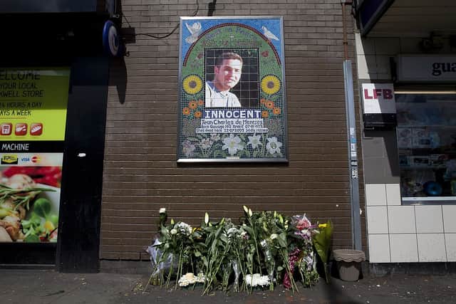 Flowers are left by a mosaic dedicated to Brazilian Jean Charles de Menezes outside Stockwell Underground station on the tenth anniversary of his death in London on July 22, 2015. Credit: JUSTIN TALLIS/AFP via Getty Images