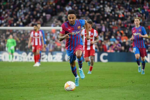 Barcelona's Gabonese midfielder Pierre-Emerick Aubameyang runs with the ball during the Spanish league football match between FC Barcelona and Club Atletico de Madrid at the Camp Nou stadium in Barcelona on February 6, 2022