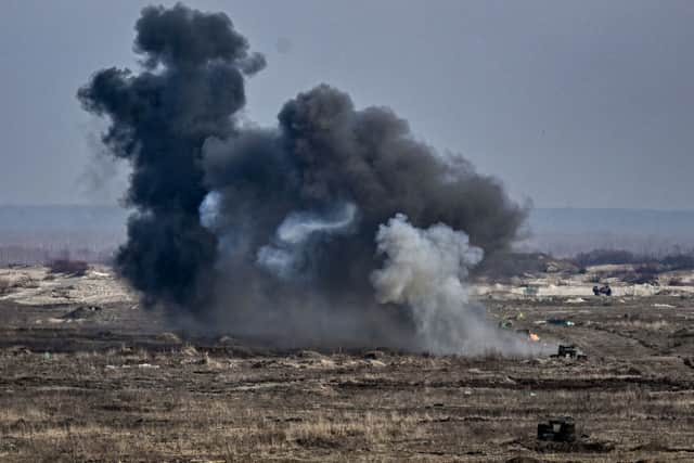 Ukrainian troops take part in a military drill outside the city of Rivne on February 16, 2022. (Photo by ARIS MESSINIS/AFP via Getty Images)