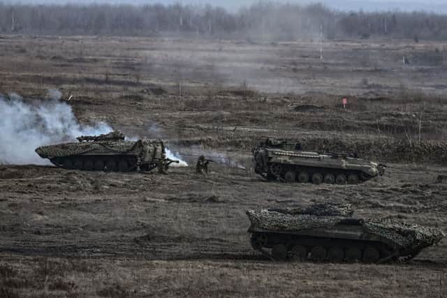 Ukrainian troops take part in a military drill outside the city of Rivne on February 16, 2022. (Photo by ARIS MESSINIS/AFP via Getty Images)