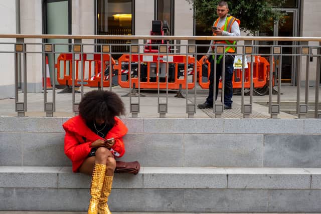 A fashionista sits on the pavement outside the British Fashion Council Show Space during London Fashion Week on September 16, 2019 in London, England. (Photo by Peter Dench/Getty Images)