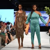Designer with models walking the runway at London Fashion Week. Credit: Jeff Spicer/Getty Images for House of iKons
