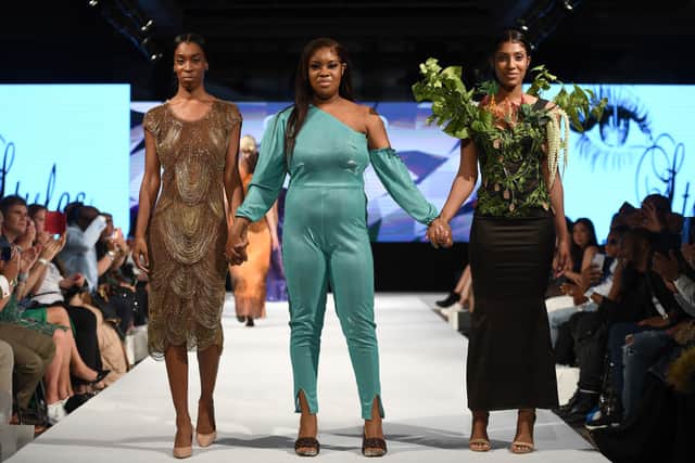 Designer with models walk the runway at London Fashion Week. Credit: Jeff Spicer/Getty Images for House of iKons