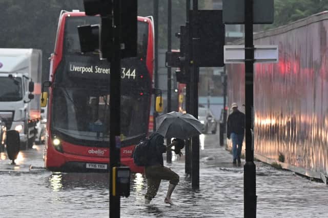 Flooding in London last summer. (Photo by JUSTIN TALLIS/AFP via Getty Images)