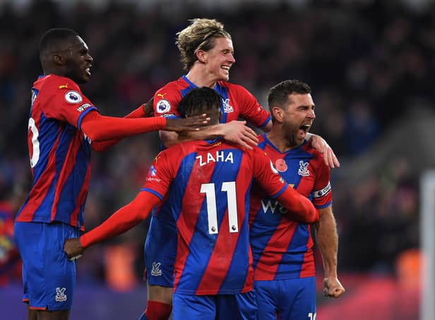 <p> Conor Gallagher celebrates with teammates Christian Benteke and Wilfried Zaha (Photo by Tom Dulat/Getty Images)</p>