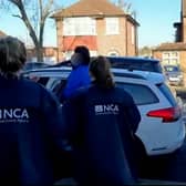 A British national wanted in Belgium for trying to help smuggle a boat of refugees across the Channel to the UK has been arrested in London. Credit: NCA / SWNS