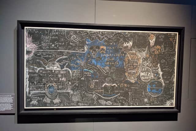 Stephen Hawking's blackboard filled with academic doodles and jokes.