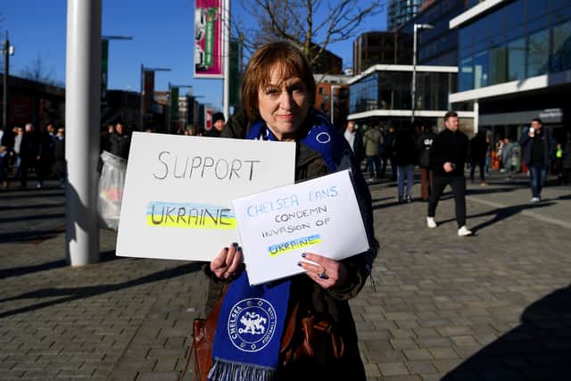 A Chelsea fan holds a banner in support of Ukraine to indicate peace and sympathy Photo by Michael Regan/Getty Images)