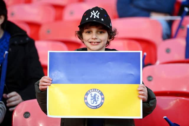 A Chelsea fan holds a banner in support of Ukraine to indicate peace and sympathy with Ukraine (Photo by Michael Regan/Getty Images)