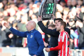 Danish midfielder Christian Eriksen (R) prepares to come on as substitute during the English Premier League (Photo by GEOFF CADDICK/AFP via Getty Images)