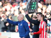 Danish midfielder Christian Eriksen (R) prepares to come on as substitute during the English Premier League (Photo by GEOFF CADDICK/AFP via Getty Images)