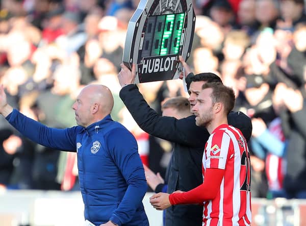 Christian Eriksen (R) prepares to come on as substitute during the Premier League. Credit: Getty. 