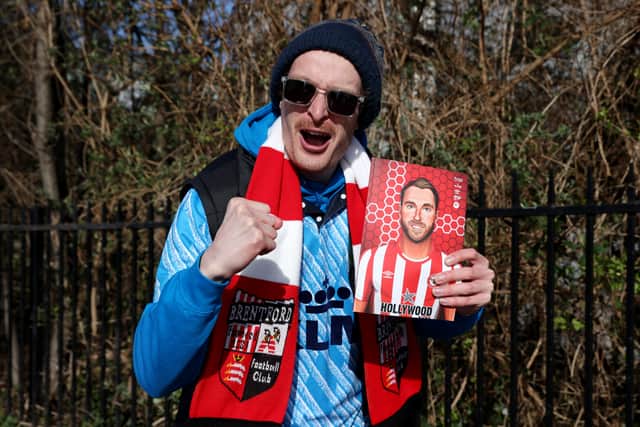  A Brentford fan holds a matchday programme (Photo by Luke Walker/Getty Images)