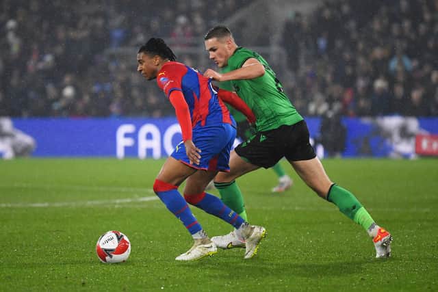 Michael Olise of Crystal Palace battles for possession with Taylor Harwood-Bellis of Stoke (Photo by Tom Dulat/Getty Images)