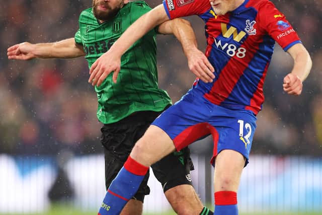 Will Hughes of Crystal Palace challenges for the high ball with Tommy Smith of Stoke City (Photo by Warren Little/Getty Images)