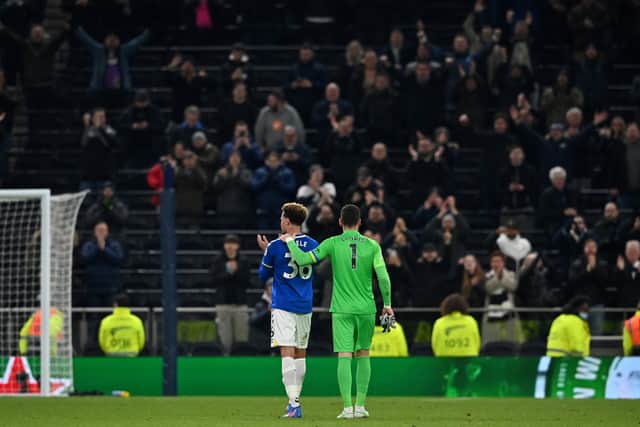 Tottenham Hotspur's French goalkeeper Hugo Lloris walks former teammate Everton's English midfielder Dele Alli (Photo by BEN STANSALL/AFP via Getty Images)