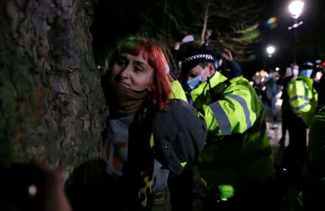 A woman is arrested during a vigil for Sarah Everard on Clapham Common. Credit: Hollie Adams/Getty Images