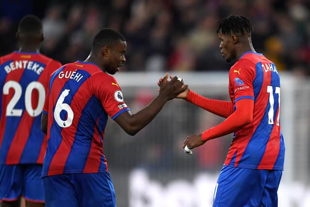 Wilfried Zaha celebrates with Marc Guehi of Crystal Palace after scoring their team's first goal (Photo by Tom Dulat/Getty Images)